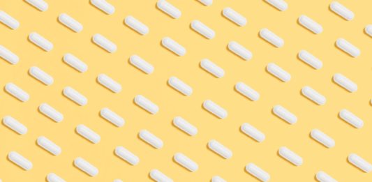 Top 12 Key Nutrients for Life Extension white capsules on yellow background