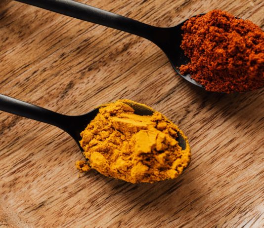 How Can Turmeric Heal The Damaged Brain? ground turmeric and hot paprika on cutting board