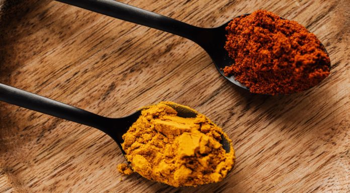 How Can Turmeric Heal The Damaged Brain? ground turmeric and hot paprika on cutting board