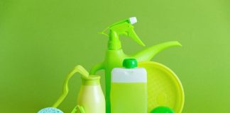 7 Non-Toxic Natural Cleaning Products reusable containers and crumpled bottle with kitchen utensils