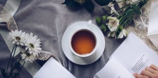 10 Scientifically Supported Health Benefits Of Drinking Tea white ceramic teacup with saucer near two books above gray floral textile