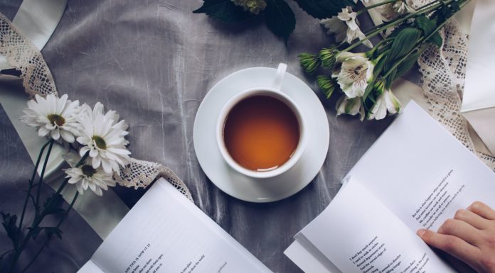 10 Scientifically Supported Health Benefits Of Drinking Tea white ceramic teacup with saucer near two books above gray floral textile